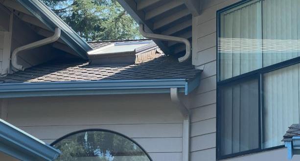 Downspout and eave trim detail on a home's roofline