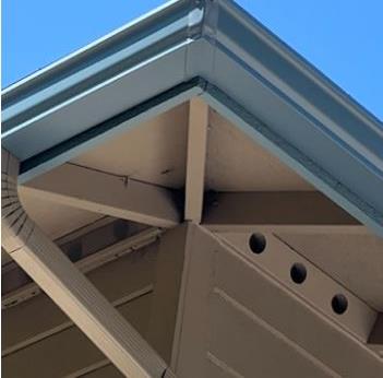 Clean corner seam on a newly installed seamless gutter, the exact spot where splash guards are needed