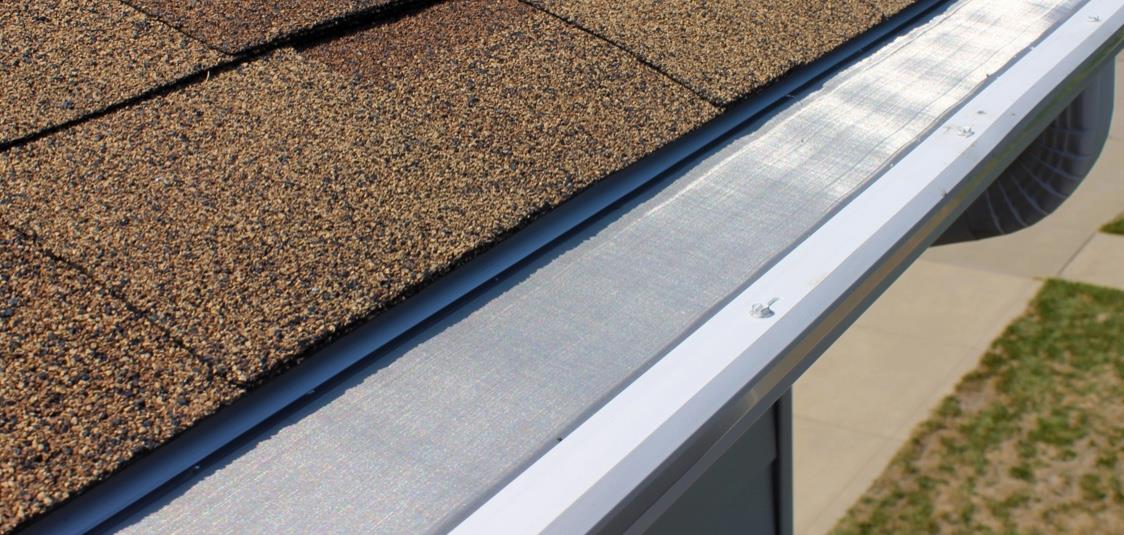 Close-up of fine micro mesh gutter guard fastened along a seamless gutter
