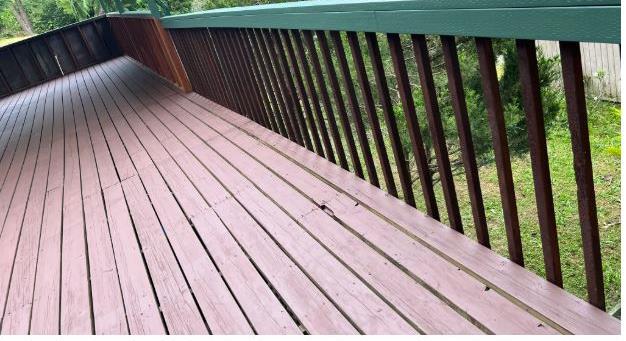 Deck and railing along a covered porch, a common pressure washing surface